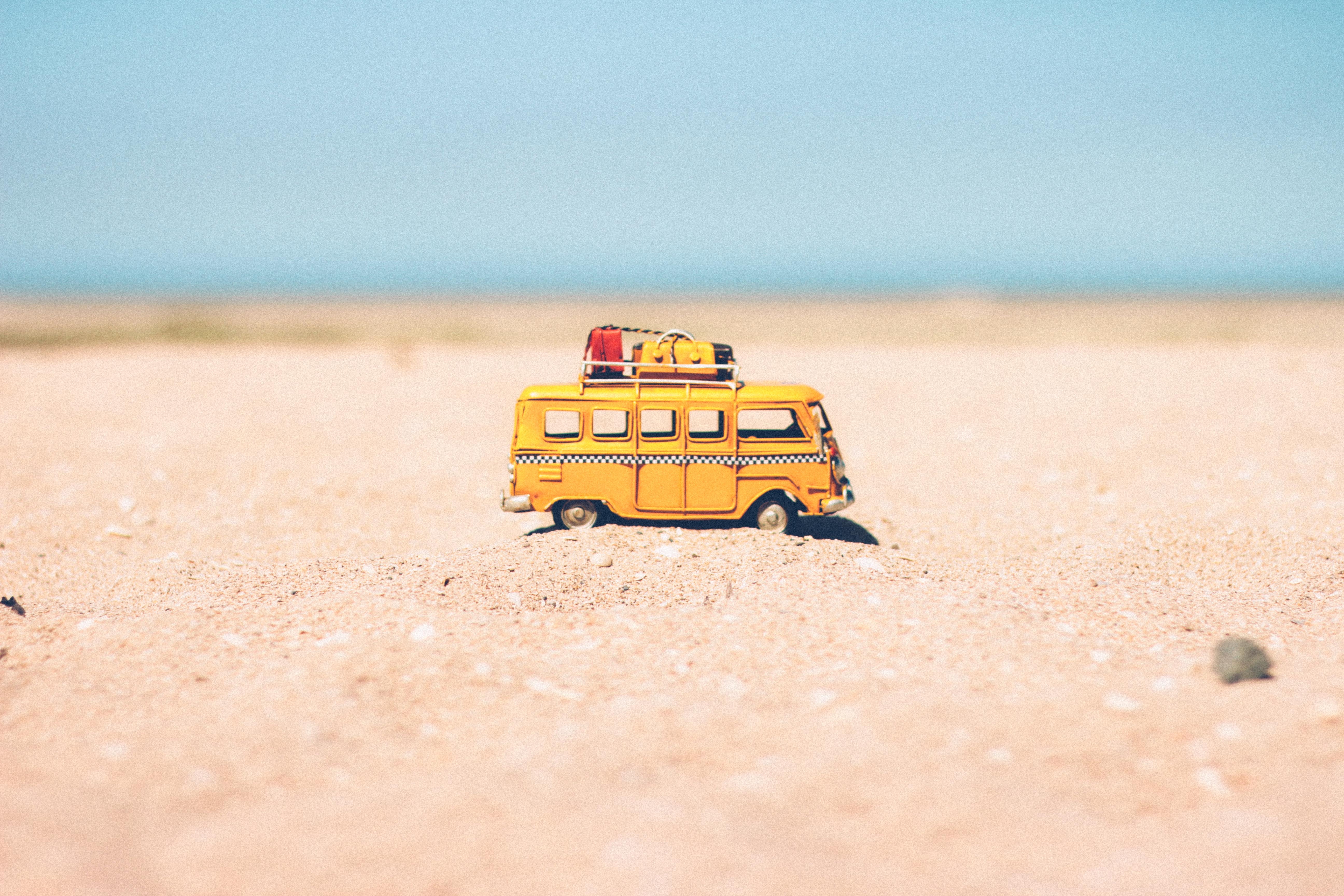 mały żółty samochodzik na plaży.jpg